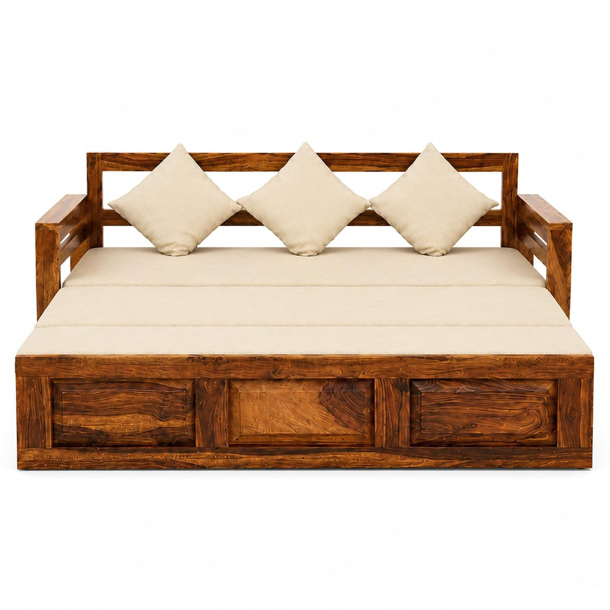 A sheesham wooden daybed with a rich medium-brown finish, featuring a thick cream-colored cushion and three matching square pillows, set against a plain white background.
